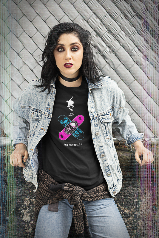 Young woman wearing a black organic cotton t-shirt, with 2 skateboard decks crossed over – one magenta with a white skull design and one black with cyan skulls design – and a white silhouette of a skater leaping over them. She looks cool in her Sub Threads T-shirt -  definitely too cool to smile in her snow-washed denim jacket - or maybe she's just deep in thought about how sustainable and eco-friendly the production and fulfilment of Sub Threads products is?